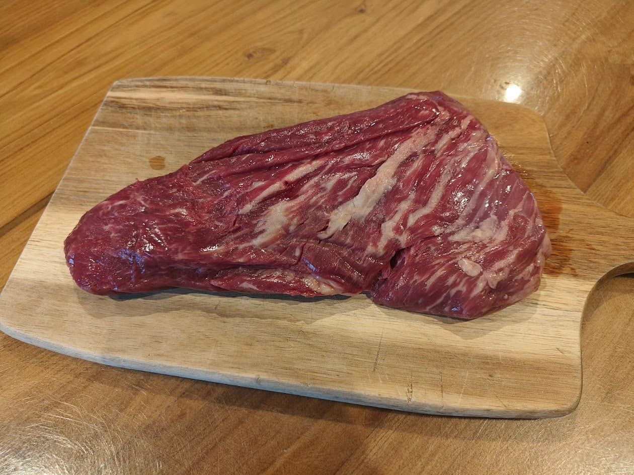 Raw beef on a wooden cutting board