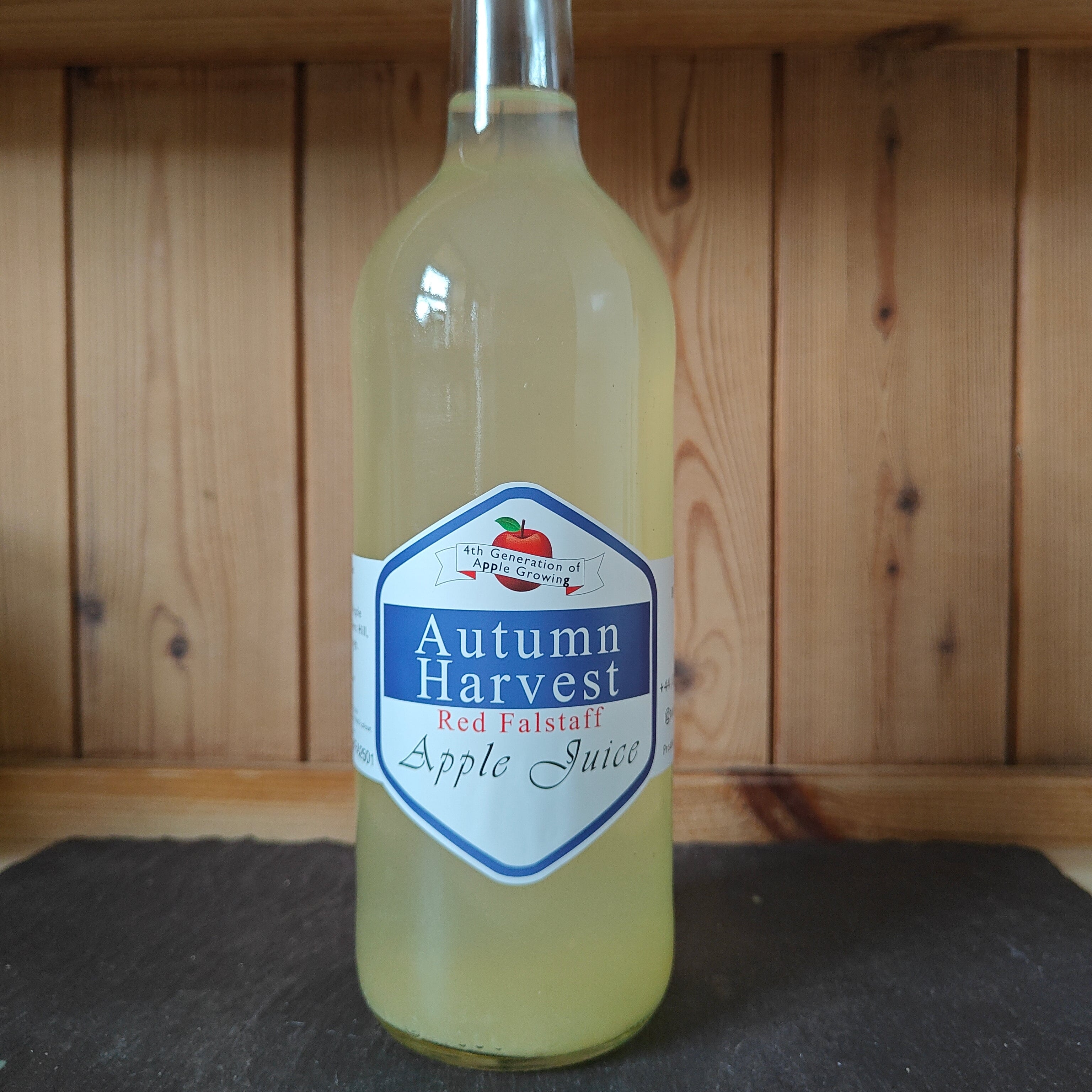 Bottle of Autumn Harvest Apple Juice on a wooden shelf