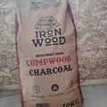 Bag of Iron Wood lumpwood charcoal on a stone surface