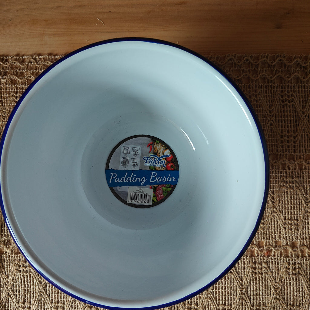 White enamel basin with a blue rim on a textured surface