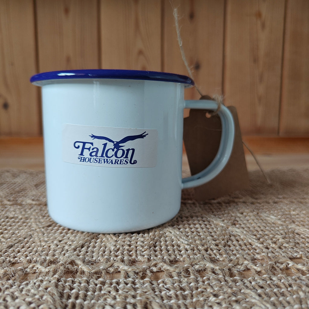 White mug with blue rim and Falcon Housewares logo on a textured surface.